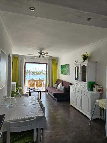 a living room with a couch and a table at Carabela in Port d'Alcudia