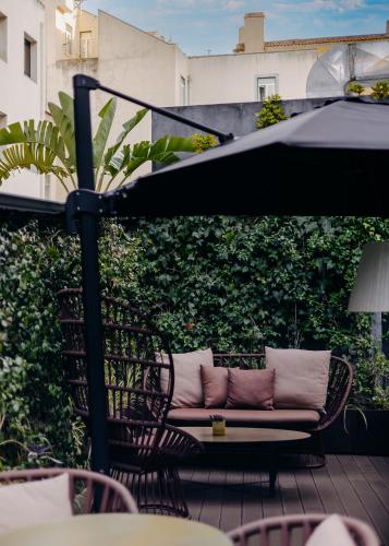 a couch sitting on top of a patio at 138 Liberdade Hotel in Lisbon
