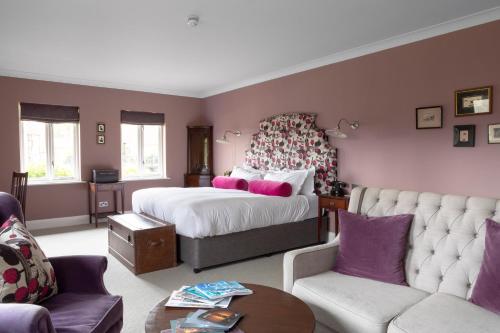 a bedroom with a bed and a living room at Burley Manor in Burley