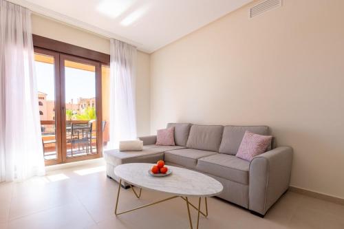 a living room with a couch and a table at Serene Escape Near the Sea - Pool &Private Parking in Los Alcázares