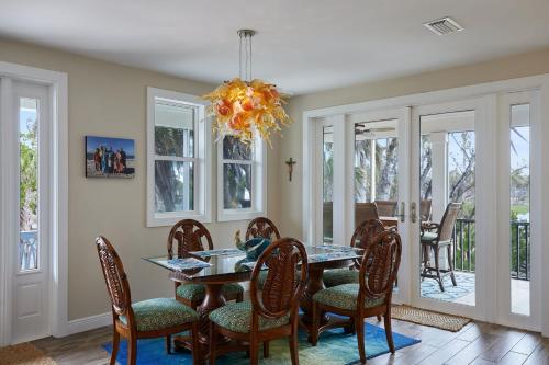 a dining room with a table and chairs at Gorgeous Villa in Coveted Butterknife Community in Sanibel
