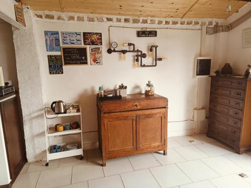a kitchen with a wooden cabinet in a room at La casa sul tetto, Room's & Glamping in Recanati