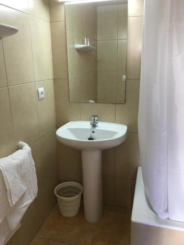 a bathroom with a sink and a mirror at Hostal Residencia Nicolau in San Antonio
