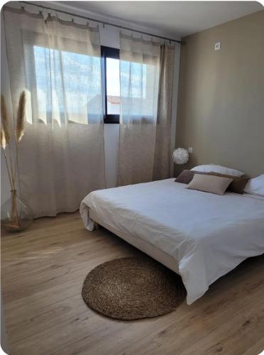 une chambre avec un grand lit et une grande fenêtre dans l'établissement Magnifique Villa piscine jacuzzi privé, à Saint-Féliu-dʼAvall