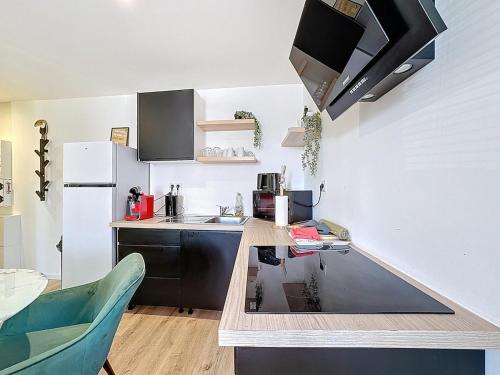 a small kitchen with a counter and a refrigerator at Séjour en groupe Immeuble 10 pers, Aulnat in Aulnat