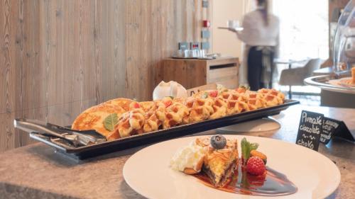 a tray of food on a counter with a plate of food at Paradise Lodge in Livigno