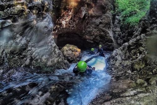 a group of people in a river in a waterfall at SISSI MENDEL Residence in Ronzone