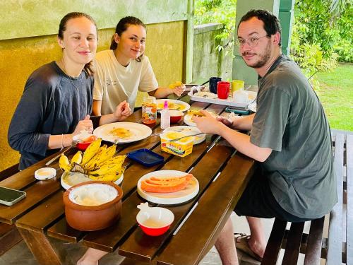 a group of people sitting at a table eating food at Aura Villa in Polonnaruwa
