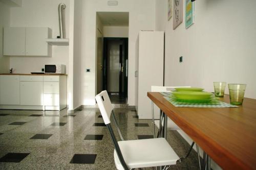 a kitchen with a wooden table with a green bowl on it at Business Apartments in Foggia