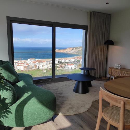 a living room with a view of the ocean at Afrodite Styling Penthouse in Nazaré