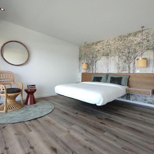 a bedroom with a large bed and a mirror at Afrodite Styling Penthouse in Nazaré