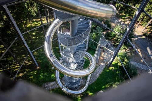 an spiral staircase in a park with a person on it at Landal Marina Lipno in Lipno nad Vltavou