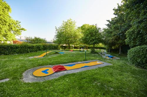 a park with a skateboard ramp in the grass at Landal Village Leau Dheure in Froid-Chapelle