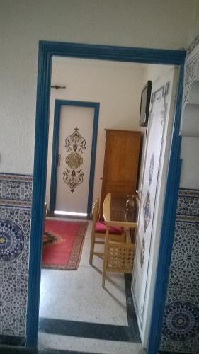 a doorway into a room with a table and a chair at Hotel Tiout in Taroudant