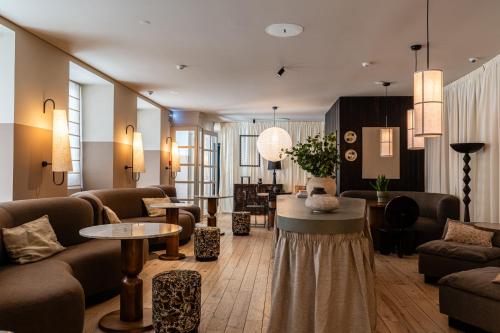 a living room with a couch and a table at Casa Teva Lisboa Boutique Hotel by chic&basic in Lisbon