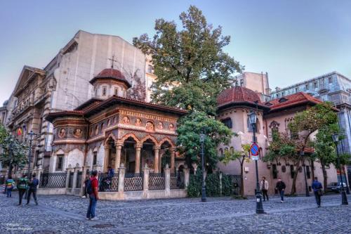 a large building with people standing in front of it at Promenada Old Town Apartments in Bucharest