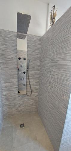 a bathroom with a shower with a wall at Villa Mira Bed and Breakfast in Duino