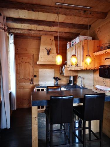 une cuisine avec une table et des chaises dans une cabine dans l'établissement GITE COSY 