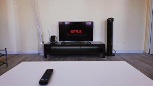 a living room with a tv and a remote control at Cozy Suite #1 in the Heart of DT Quebec with QB in Quebec City