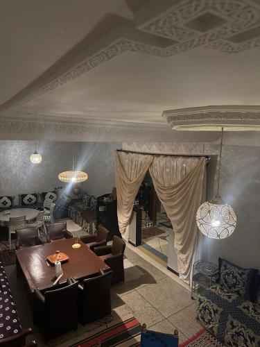 a living room with a table and chairs at Riad Dar Fadma in Ouarzazate