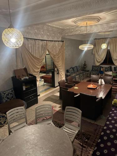 a living room with a table and chairs at Riad Dar Fadma in Ouarzazate