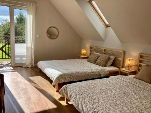 a bedroom with two beds and a window with a balcony at Przystanek 470 in Krościenko