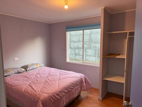 a bedroom with a bed and a window at Casa independiente muy acogedora in Puerto Varas