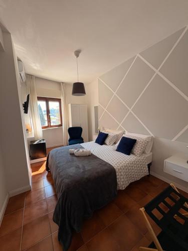 a bedroom with a large bed with blue pillows at Aniene Home Roma in Rome