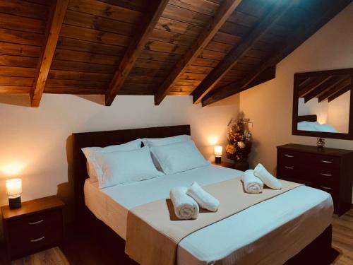 a bedroom with a bed with two pillows on it at Luxury private villa queen Alla in Dragotiná