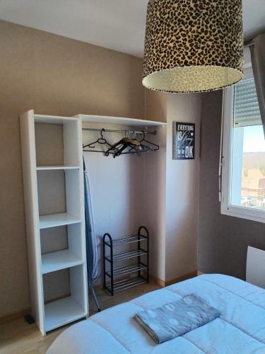 a bedroom with a bed and a book shelf at CHEZ MIMONa in Lage