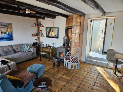 a living room with a couch and a fireplace at Honey Spa house in Novi Slankamen