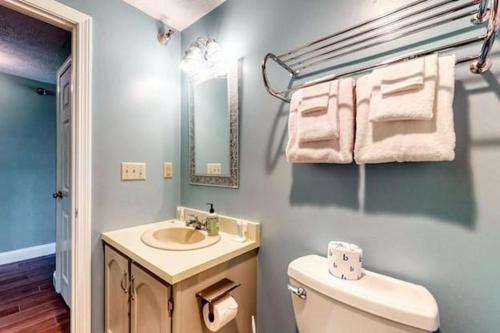 a bathroom with a sink and a toilet and a mirror at Footbridge Escape in Ogunquit