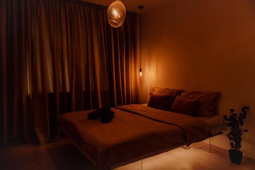a bedroom with a bed with a bag on it at Heart of Old Town in Bucharest