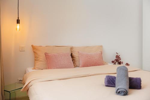 a bedroom with a bed with pink and purple pillows at Heart of Old Town in Bucharest