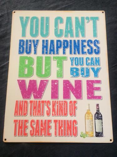 a sign that says you cant buy happiness but buywine at Château la Renommée in Saint-Laurent-des-Combes