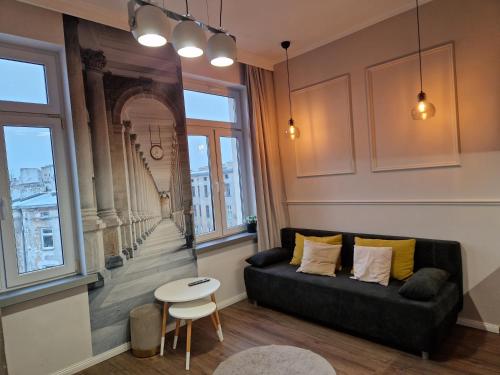 a living room with a couch and a table at Polonia Apartments in Łódź