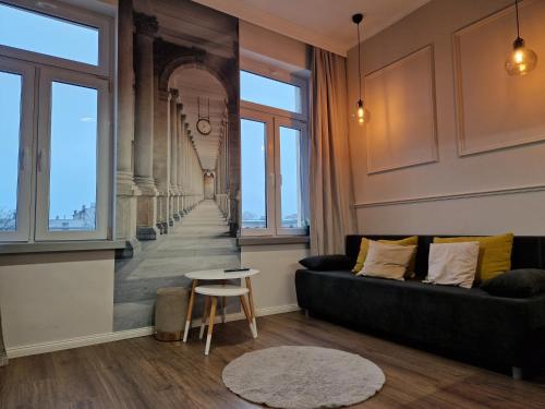 a living room with a couch and a table at Polonia Apartments in Łódź