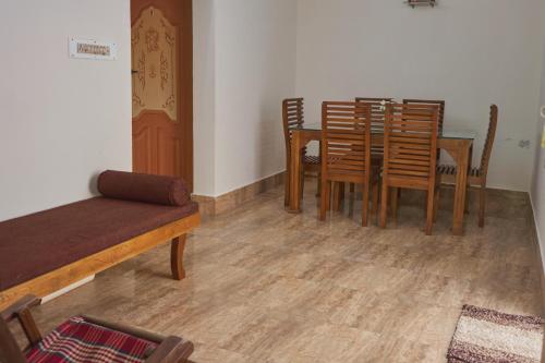 a dining room with a table and chairs at Jacob Farms in Denkanikottai