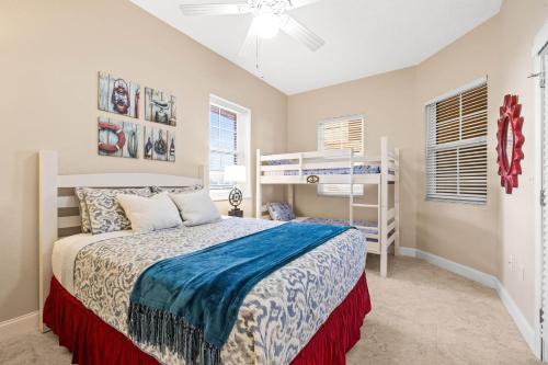 a bedroom with a bed and a bunk bed at Waterfront Breeze Condo in Clearwater Beach
