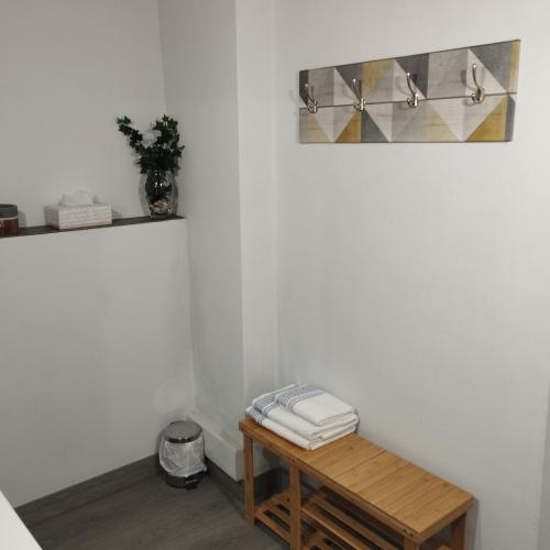 a room with a wooden table and a shelf with towels at La Milotxa in Adsubia