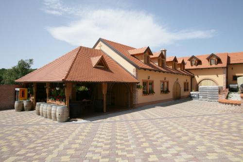 a large brick building with several tables and chairs in front of it at B&B Kolarić in Jastrebarsko