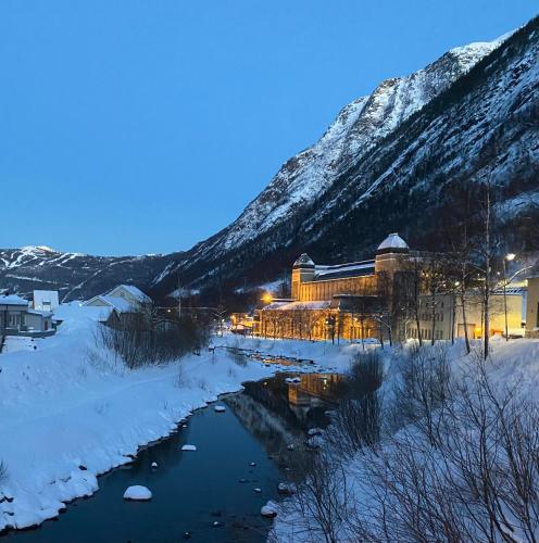 a train station in the snow next to a river at Villa Rjukan in Rjukan