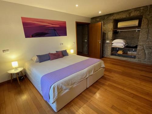 a bedroom with a large bed in a room at Casa da Aldeia in Vilela