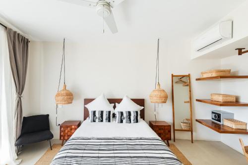 a bedroom with a bed and a chair at Casa Lulú, Oasis with Pool and Panoramic Terrace in San José del Cabo