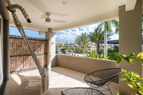 a balcony with chairs and a view of the ocean at Casa Lulú, Oasis with Pool and Panoramic Terrace in San José del Cabo