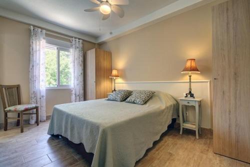 a bedroom with a bed and a ceiling fan at Duquesa Marina - Manilva Beach Home in Manilva
