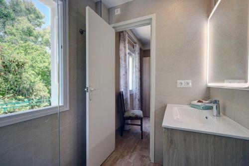 a bathroom with a sink and a window at Duquesa Marina - Manilva Beach Home in Manilva