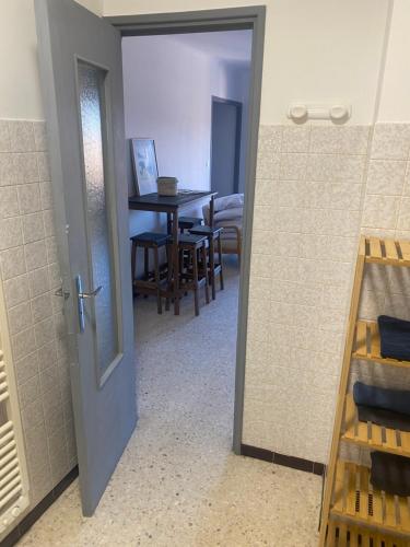 une porte menant à une salle à manger avec une table dans l'établissement Studio tout confort gorges du verdon, à Gréoux-les-Bains