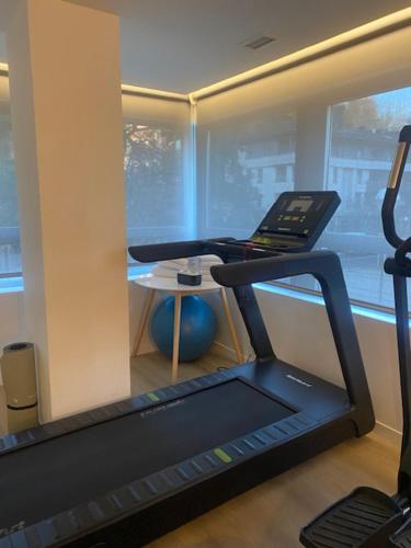 a room with a gym with a treadmill and a phone at Hotel Distrito Oeste in Donostia-San Sebastián