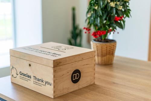 a box sitting on a table next to a potted plant at Hotel Distrito Oeste in Donostia-San Sebastián